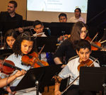 Harmony project orchestra students performing