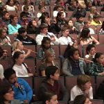 Elementary school children playing recorders in the Fred Kavli Theater