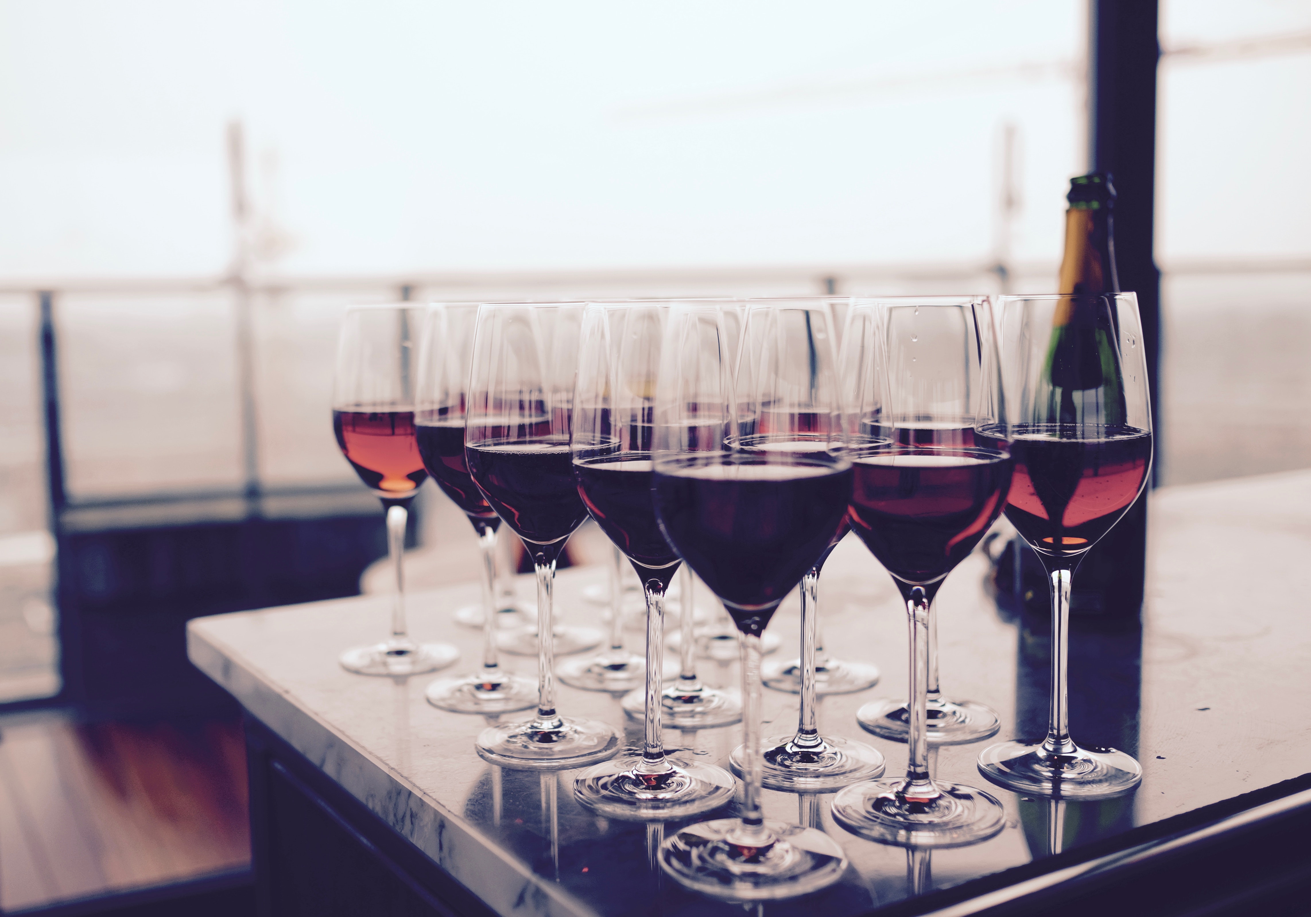 Several glasses of wine on countertop