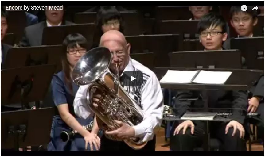 Bald-headed man playing euphonium